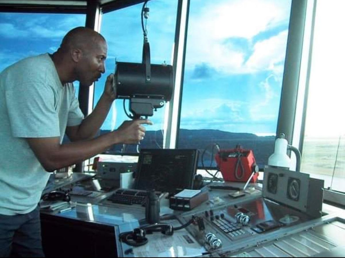 Dr. Worthington with light gun — non-radio aircraft signaling procedure.
